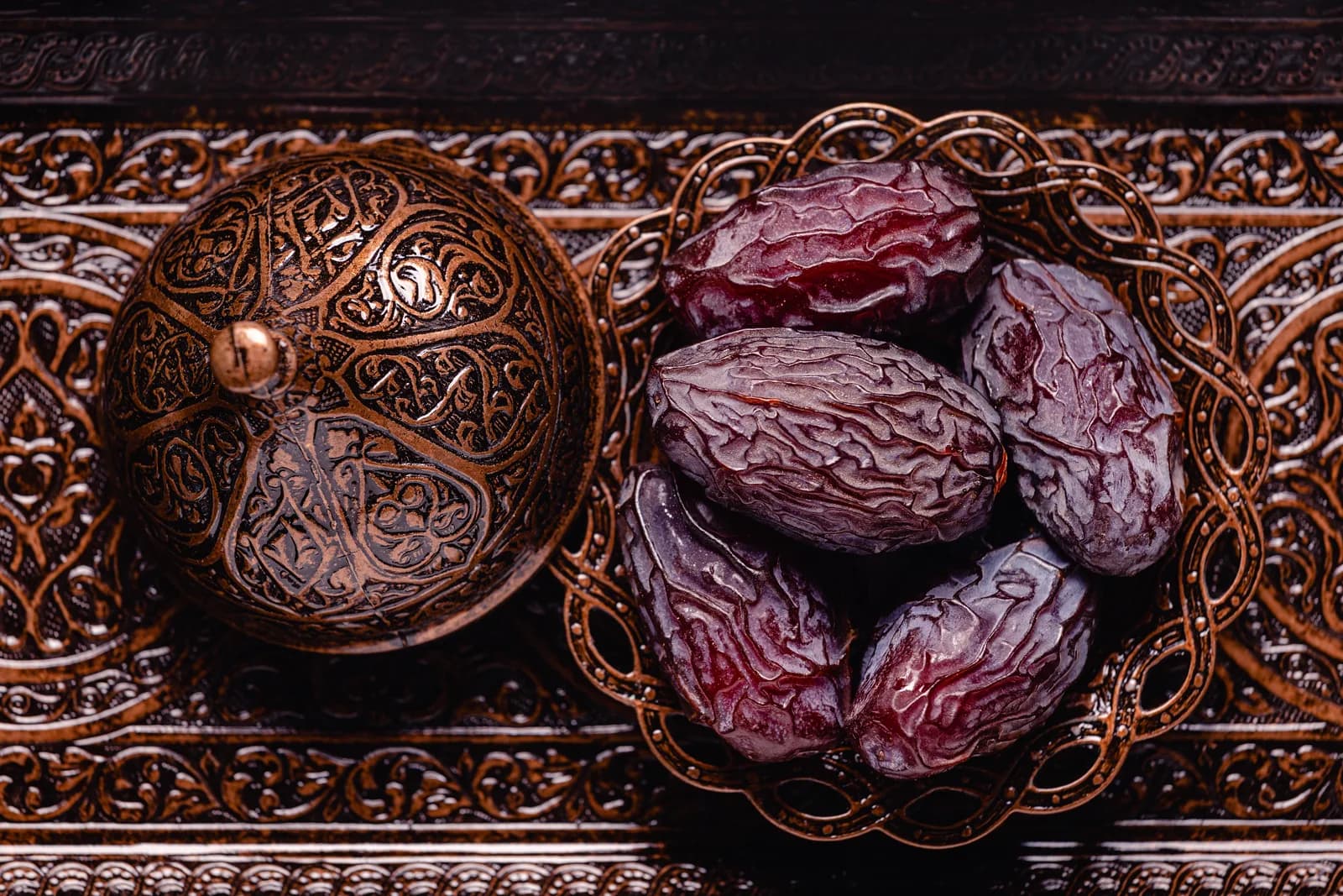 Premium Medjool dates in an ornate copper tray